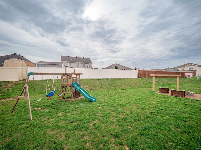 view of yard with a fenced backyard and a playground