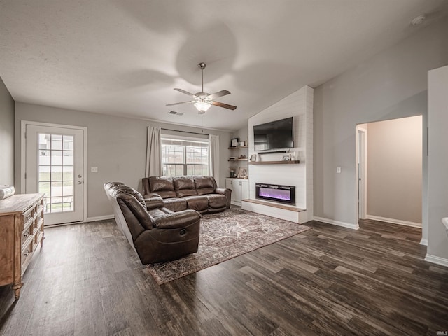 living room featuring a fireplace, ceiling fan, lofted ceiling, and dark wood finished floors