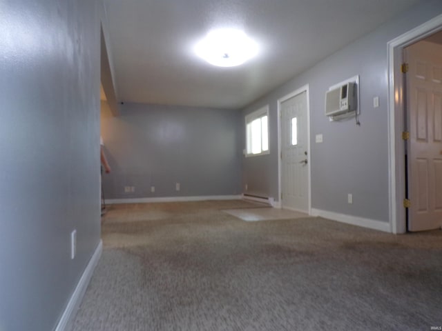 foyer with baseboards, a wall unit AC, a baseboard heating unit, and carpet flooring