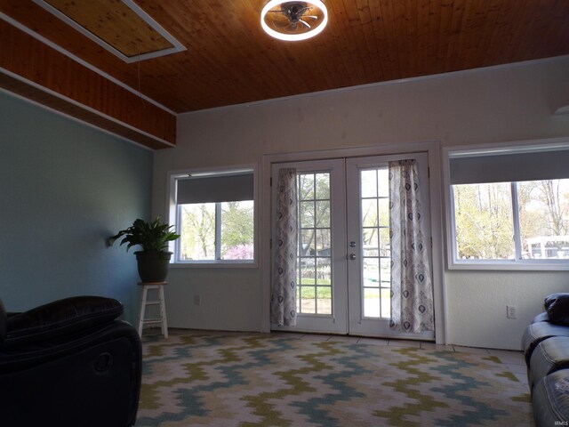 doorway to outside featuring carpet floors, french doors, and wooden ceiling