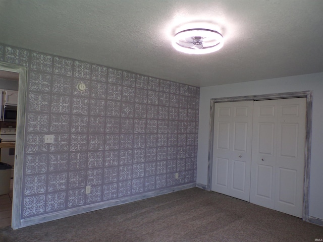 unfurnished bedroom featuring a closet, carpet floors, and baseboards