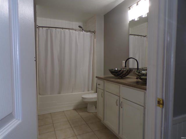 bathroom featuring shower / bath combo with shower curtain, toilet, tile patterned flooring, and vanity