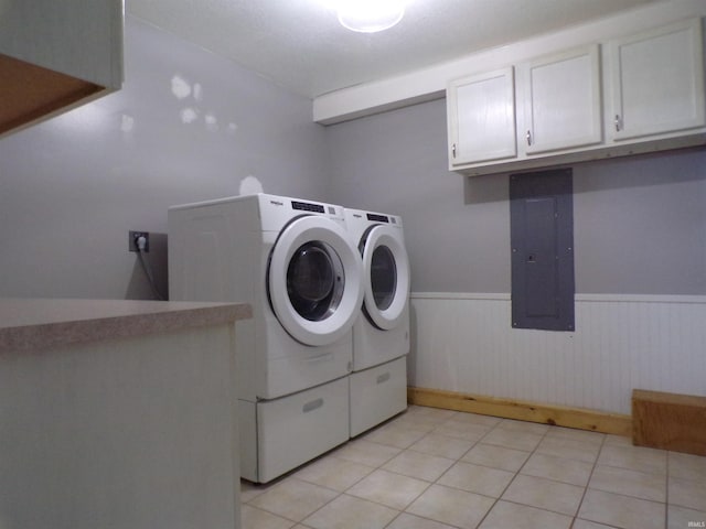 laundry area featuring independent washer and dryer, wainscoting, light tile patterned floors, cabinet space, and electric panel