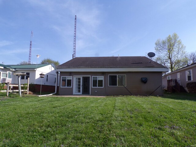 rear view of property with a yard