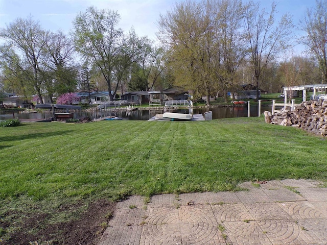 view of yard featuring a boat dock and a water view