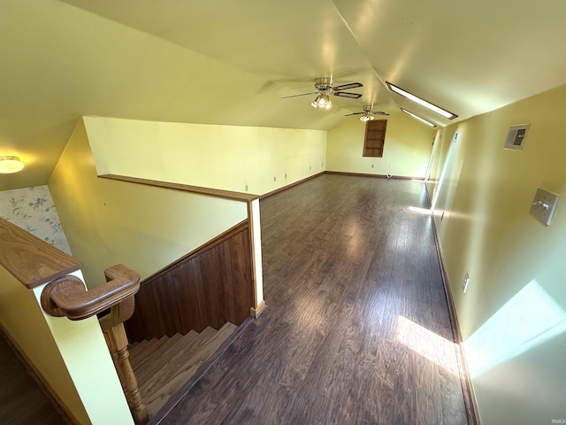 interior space featuring a ceiling fan, wood finished floors, and vaulted ceiling