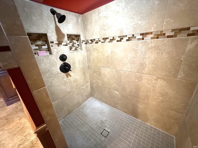 bathroom with a tile shower