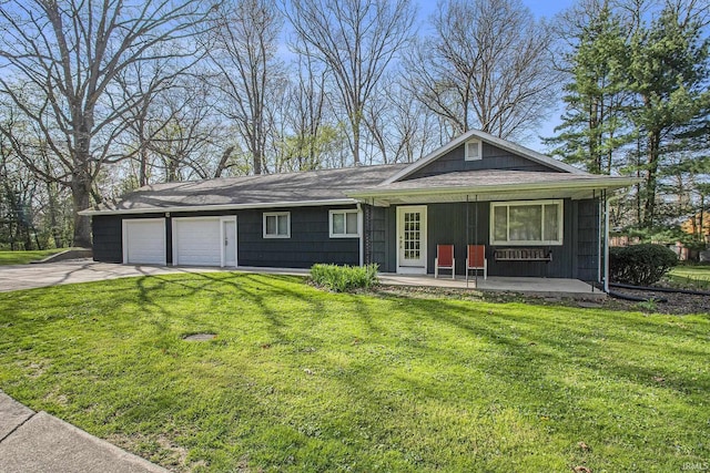 single story home featuring a porch, a garage, driveway, and a front yard