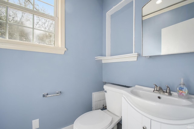 half bath featuring toilet and vanity