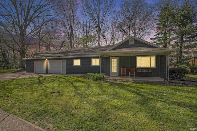 single story home with a porch, driveway, and a front yard