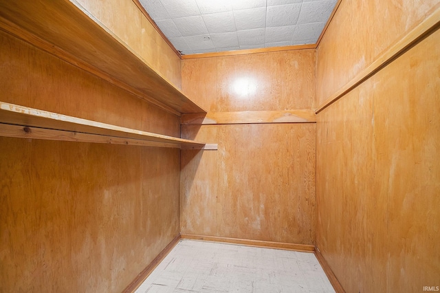 walk in closet with light floors
