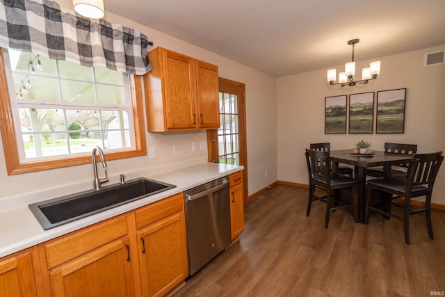 kitchen featuring an inviting chandelier, visible vents, dark wood-style flooring, a sink, and dishwasher