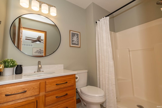 bathroom featuring a ceiling fan, visible vents, a shower stall, vanity, and toilet