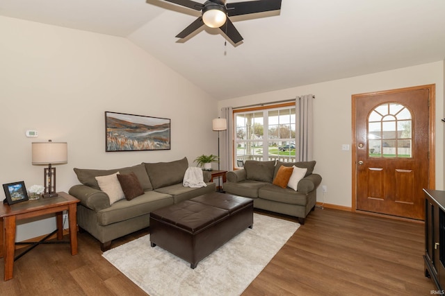 living area featuring a ceiling fan, vaulted ceiling, and wood finished floors