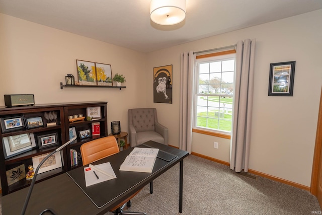 carpeted home office featuring baseboards