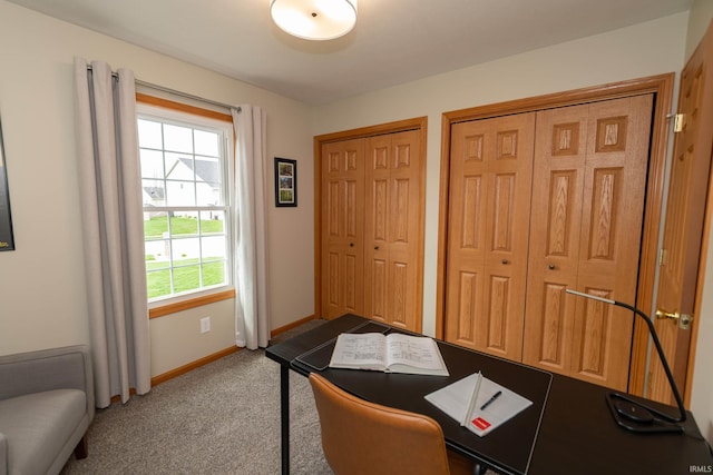 carpeted home office featuring baseboards