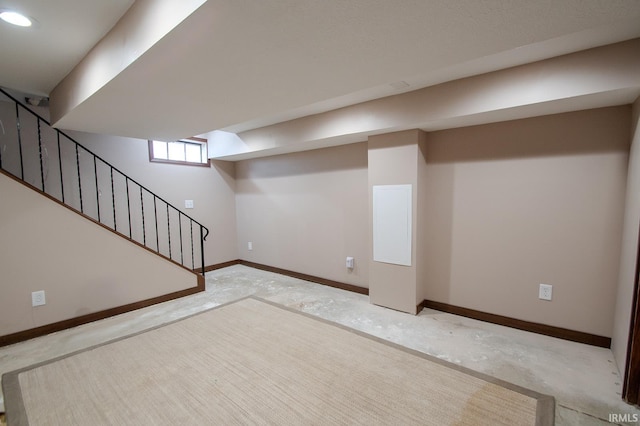 basement with stairs, recessed lighting, and baseboards
