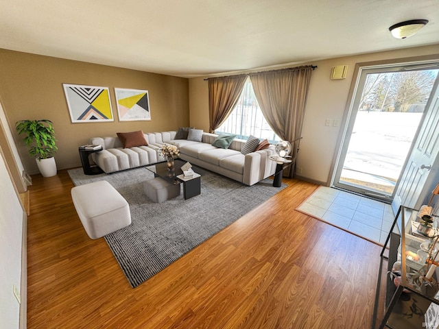 living room with light wood-style flooring and a wealth of natural light