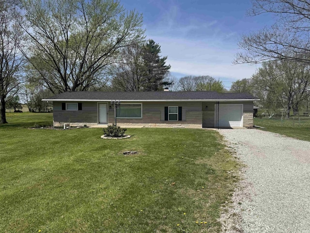 single story home featuring a garage, driveway, and a front yard