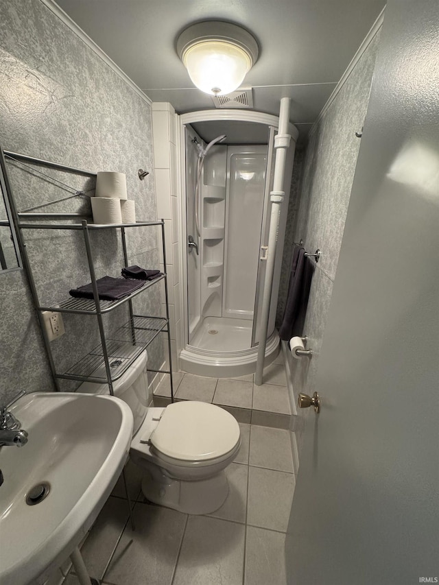 bathroom featuring a sink, toilet, tile patterned floors, visible vents, and a stall shower