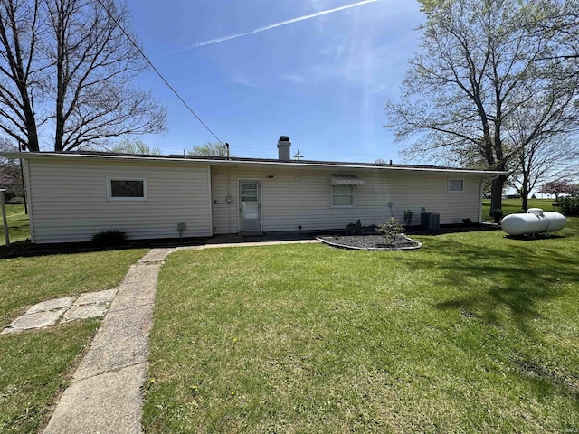 back of house with a yard and cooling unit