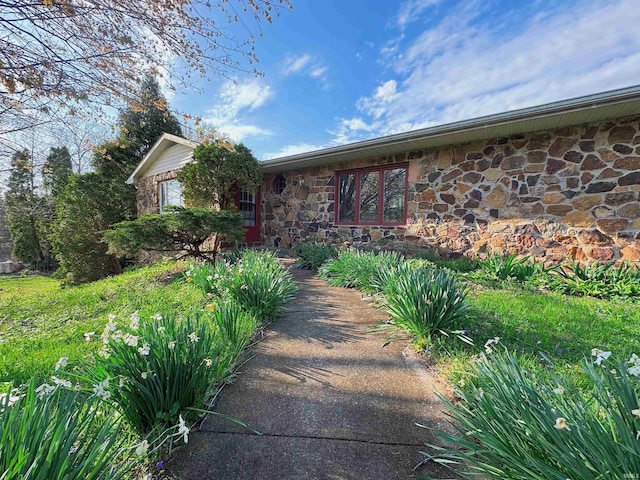 ranch-style house with stone siding