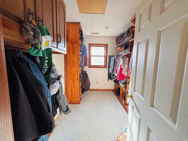 spacious closet featuring light colored carpet, attic access, and visible vents