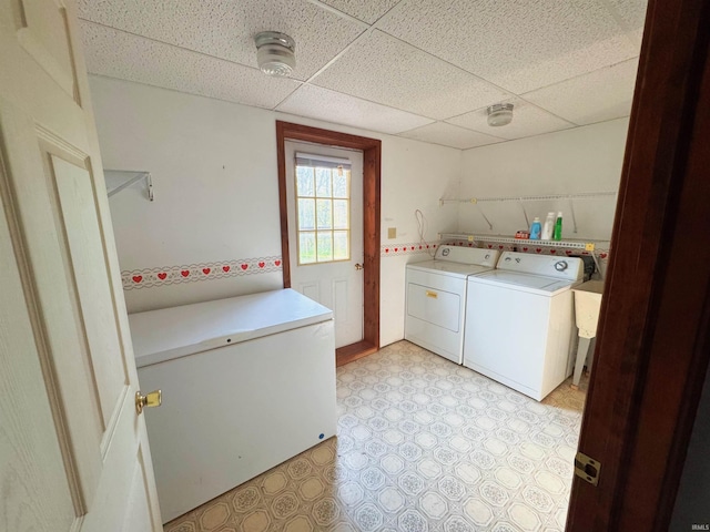 laundry area featuring light floors, laundry area, and independent washer and dryer