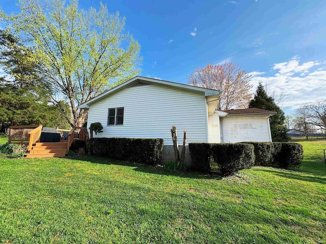 view of property exterior with a lawn and a deck