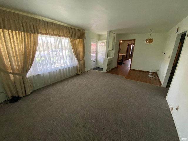 8441 E County Road 650 S, Selma, IN 47383 - unfurnished living room featuring baseboards and carpet