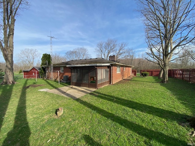 8441 E County Road 650 S, Selma, IN 47383 - exterior space featuring a lawn, fence, a chimney, and a sunroom