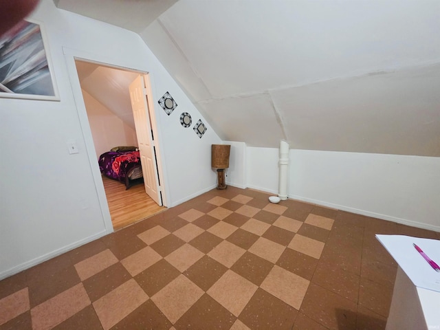 bonus room featuring baseboards and lofted ceiling