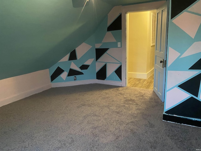bonus room with baseboards, carpet flooring, and lofted ceiling