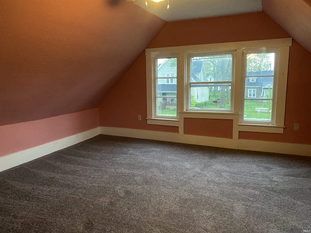 bonus room featuring baseboards, carpet flooring, and vaulted ceiling