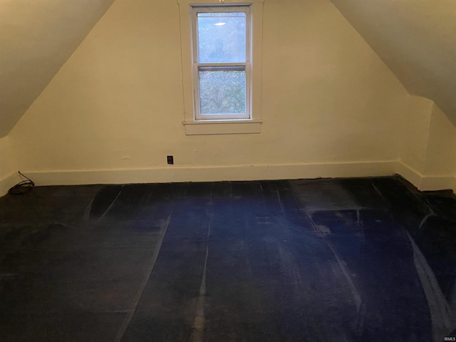 bonus room featuring baseboards and lofted ceiling