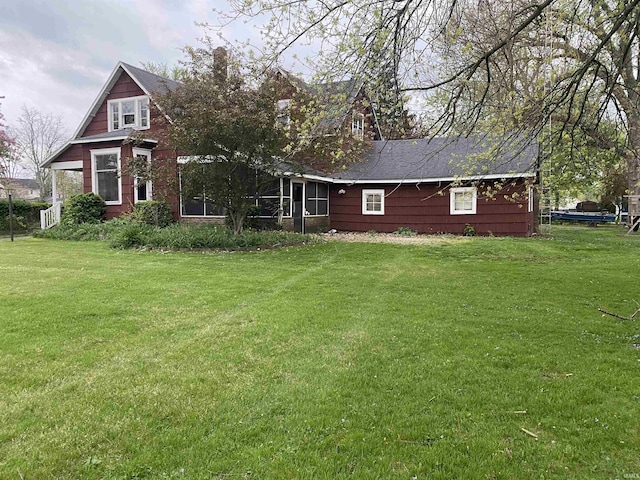 rear view of house with a lawn