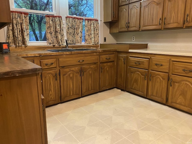 kitchen featuring brown cabinets and dark countertops