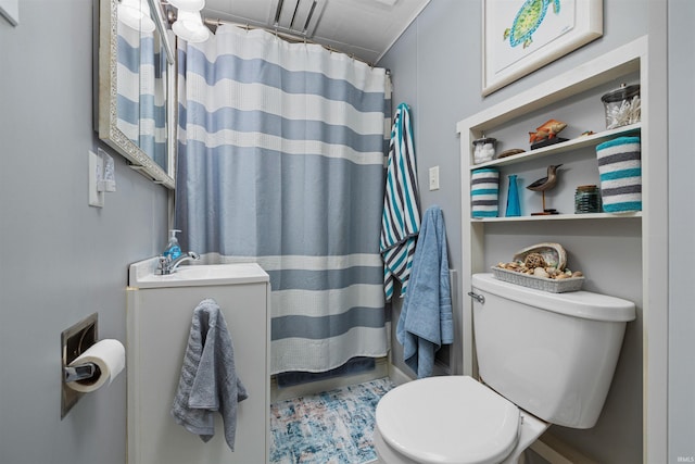 bathroom with a sink, toilet, and curtained shower