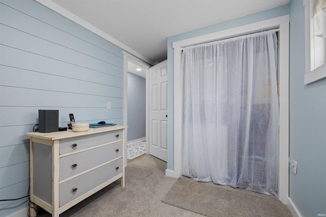 bedroom featuring baseboards and carpet