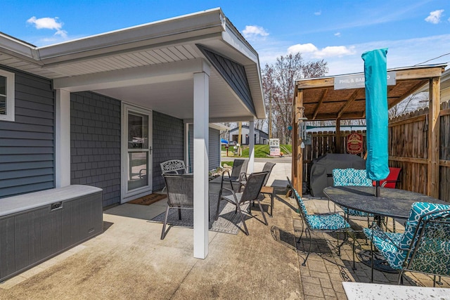 view of patio with fence and outdoor dining area