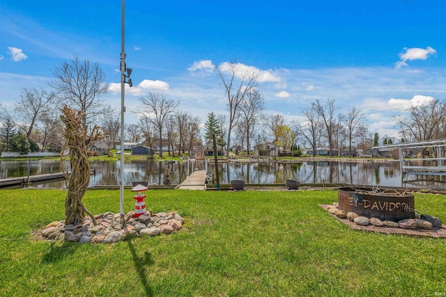 view of yard with a water view and a fire pit