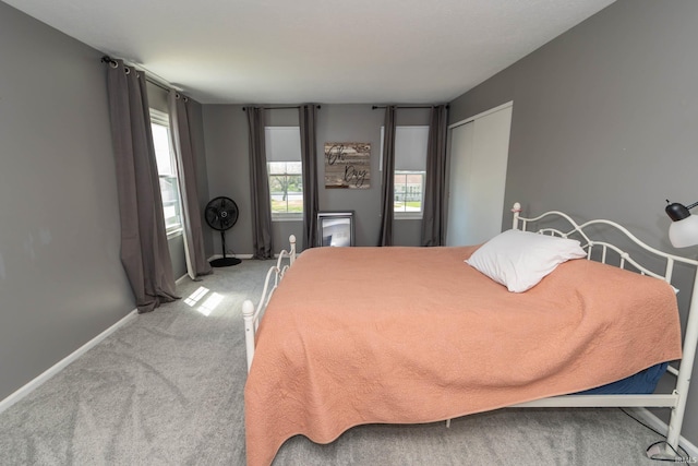 bedroom with baseboards and carpet flooring