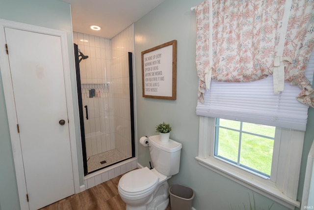 full bath with wood finished floors, toilet, baseboards, recessed lighting, and a shower stall