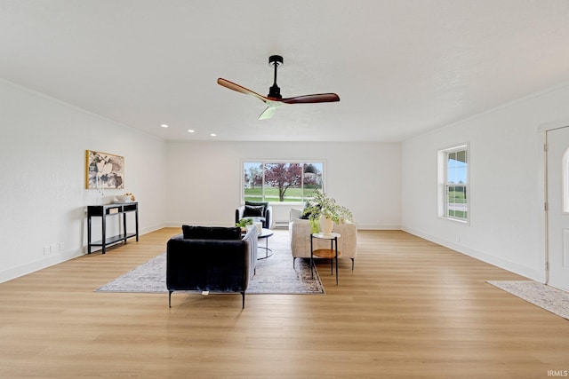 living area featuring crown molding, a ceiling fan, recessed lighting, and light wood-style flooring
