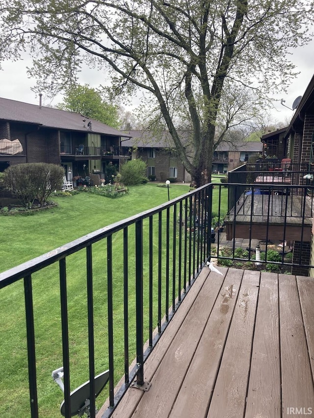 wooden terrace with a lawn and a residential view