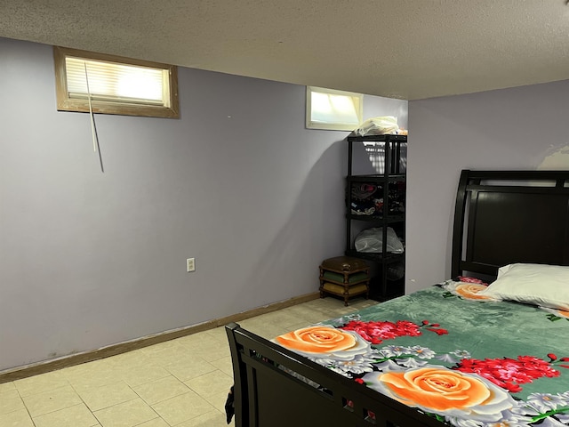 bedroom featuring baseboards and a textured ceiling