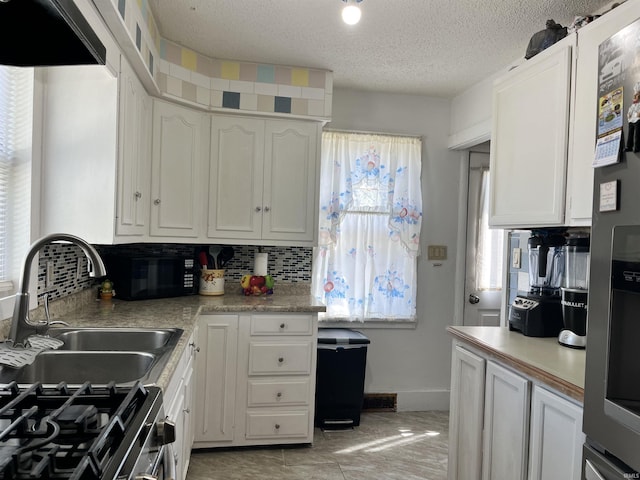 kitchen featuring a sink, white cabinetry, and appliances with stainless steel finishes