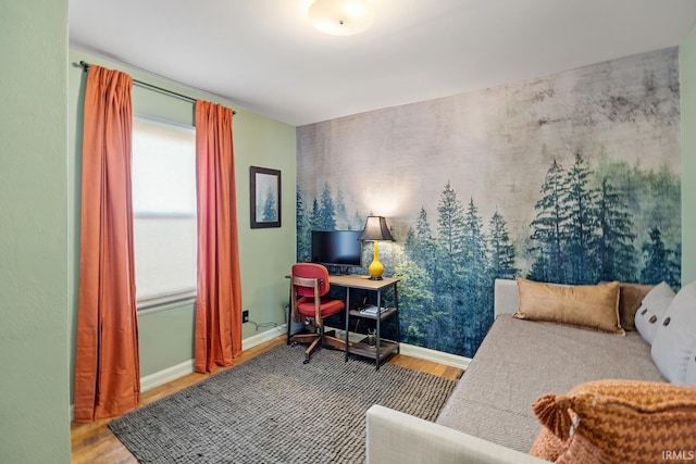 interior space with baseboards and wood finished floors