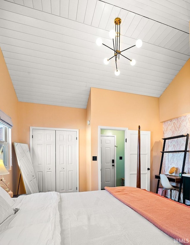 bedroom with a notable chandelier, vaulted ceiling, and a closet