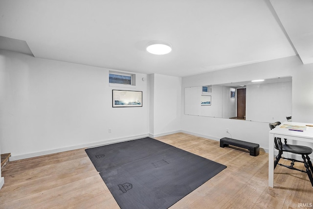 exercise area featuring baseboards and wood finished floors